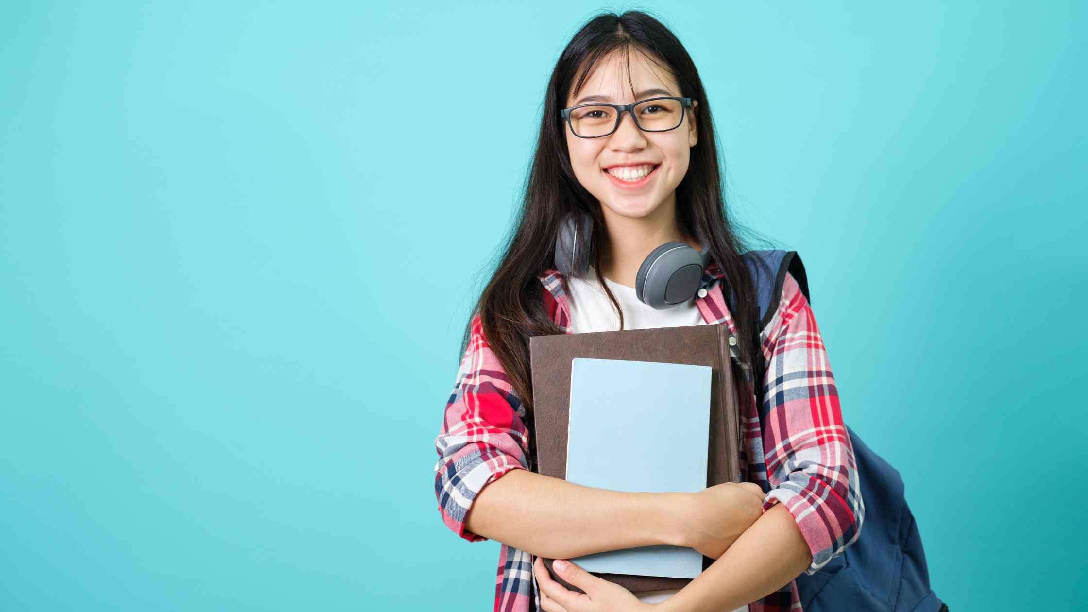 A university student & books, reflecting applicants wondering if a 1300 SAT score meets top California university standards.
