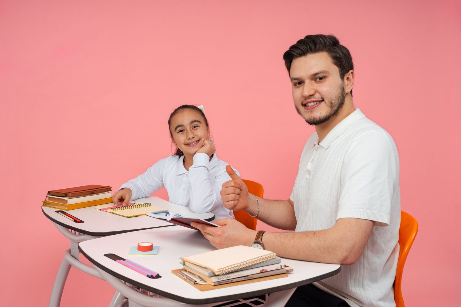 Student working at a desk with a laptop and notebook