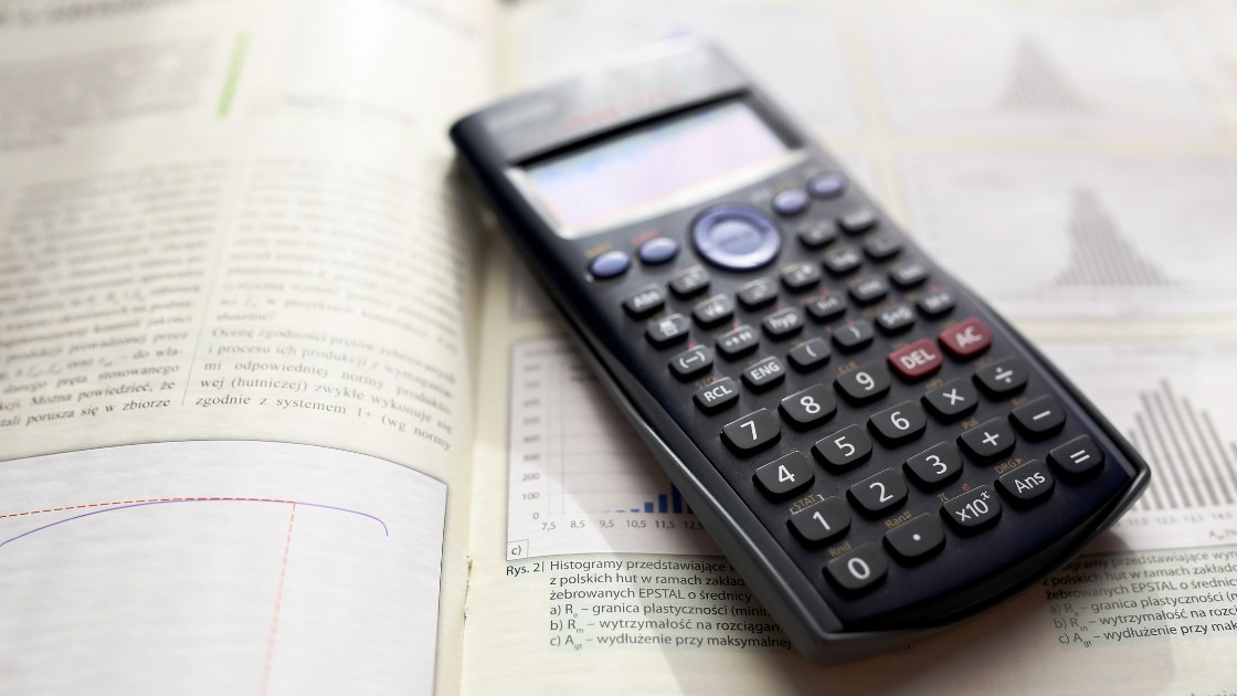 Calculator on a math textbook; illustrates algebra strategies focused on speed, pattern, and solving under time limits.