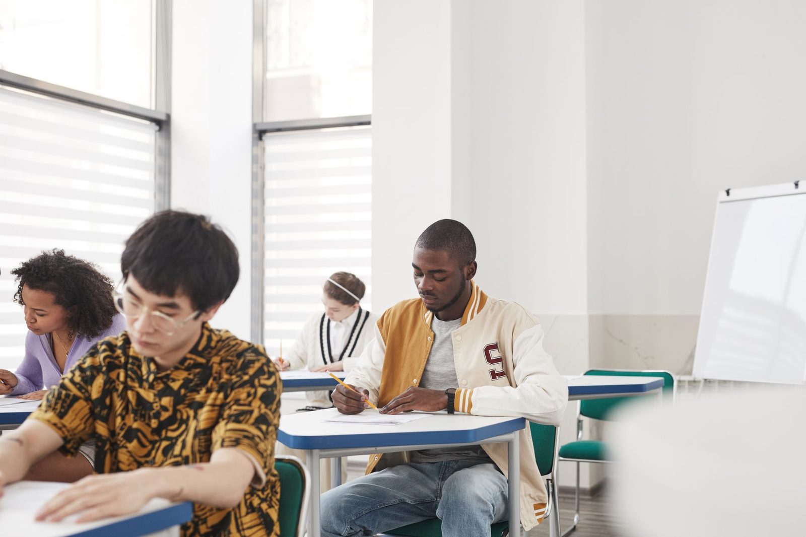 Student reviewing college application materials at a desk